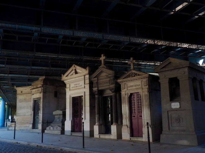 Mauseleums shaded by the big, iron bridge. 
